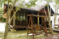 Wooden bungalow in Sorong area with wooden swing in front