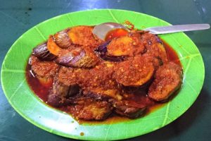 A plate of fried eggplant with sambal sauce